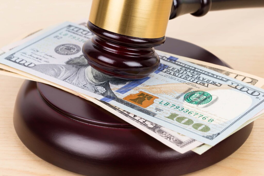 Dollar bills Judge's wooden gavel with dollar bills
